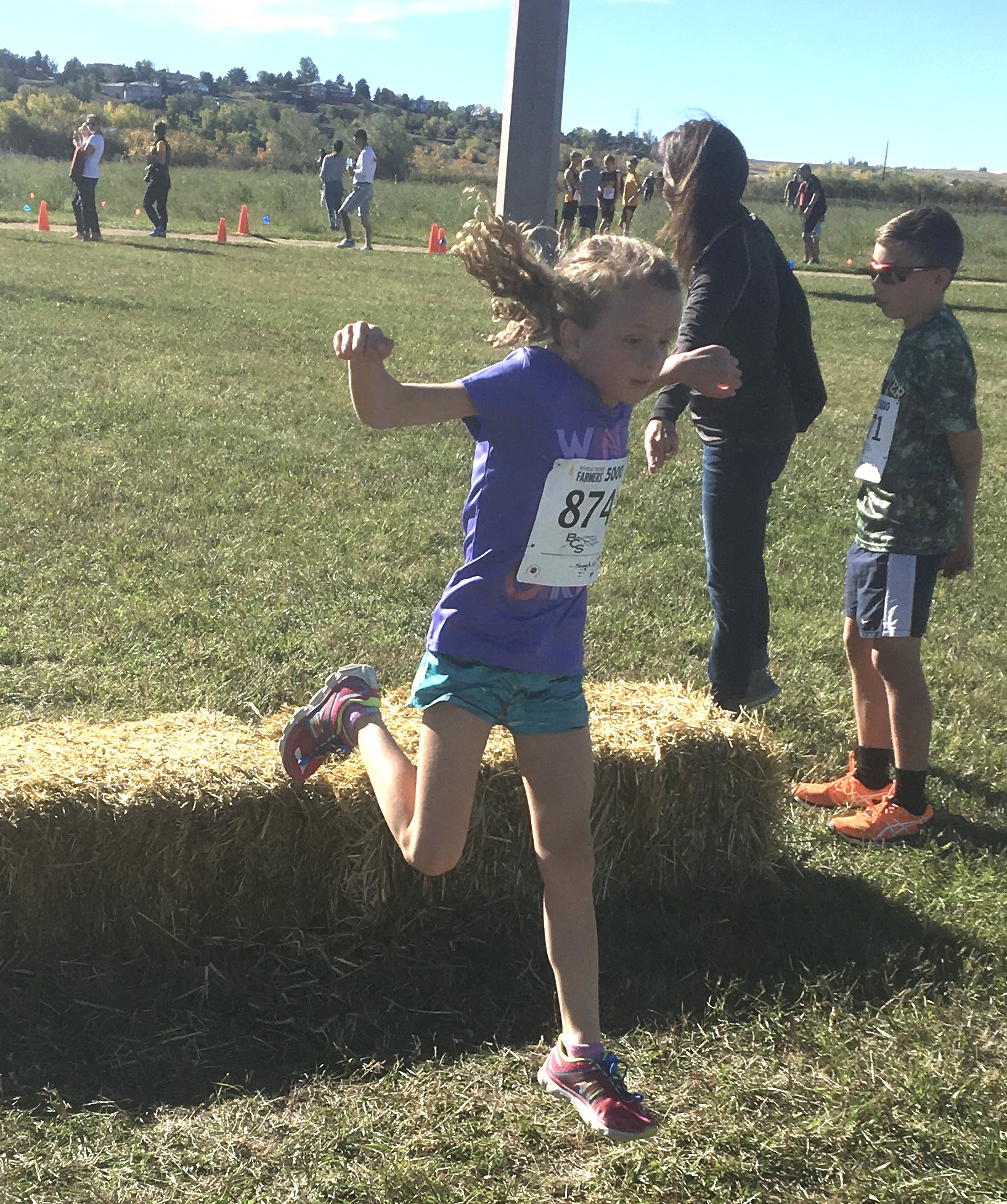 Girls jumping bale at XC race